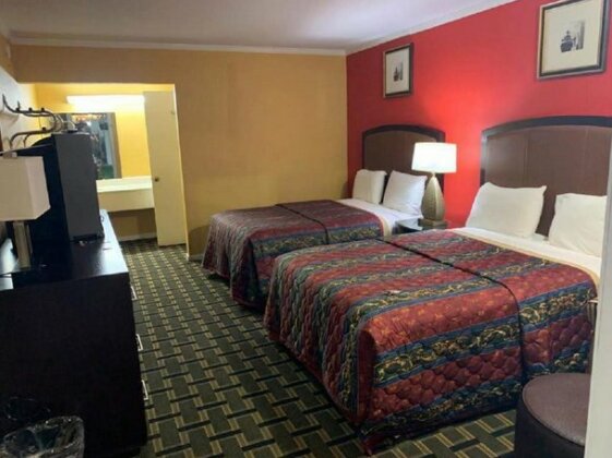 Guest room with two beds and a vanity area